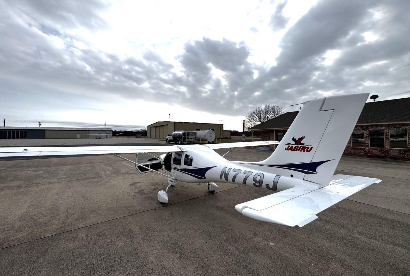 Jabiru N779J parked on the ramp in front of the hangars