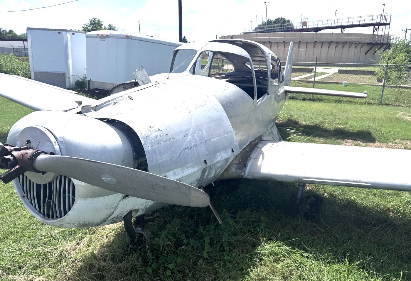 Well-worn low-wing trainer parked in the grass